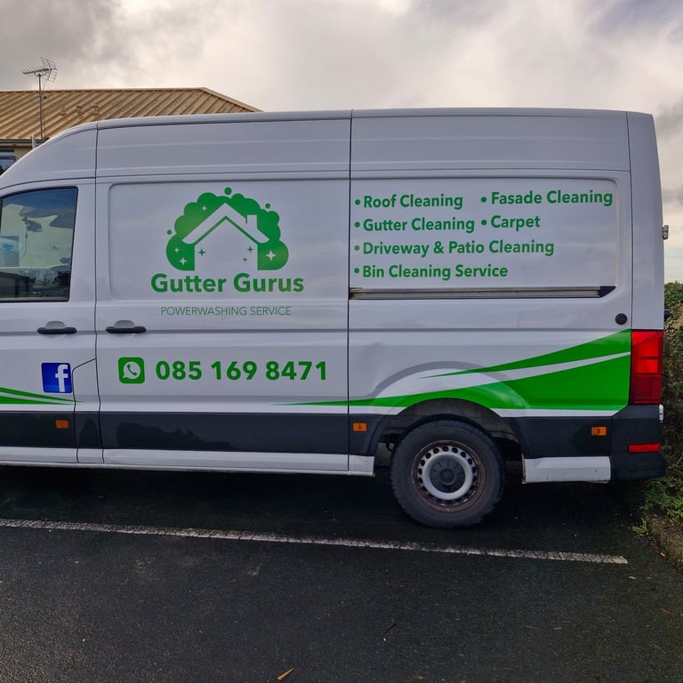White and green service van for Gutter Gurus cleaning company with contact number and list of services on the side